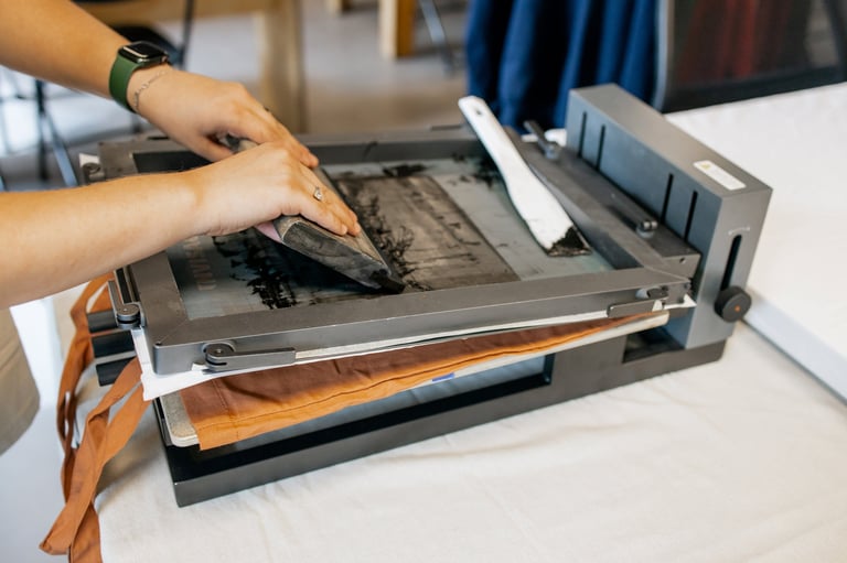 Manual silk screen printing close-up of hands working in workshop