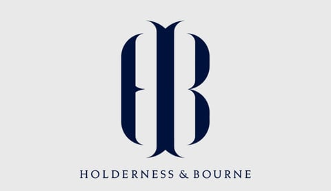 Holderness and Bourne logo featuring stylized monogram with navy blue ornamental design on light gray background